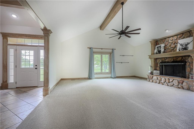 26528-23.09 S Metcalf Rd, Louisburg, KS 66053 - unfurnished living room featuring beamed ceiling, healthy amount of natural light, ceiling fan, a fireplace, and carpet flooring