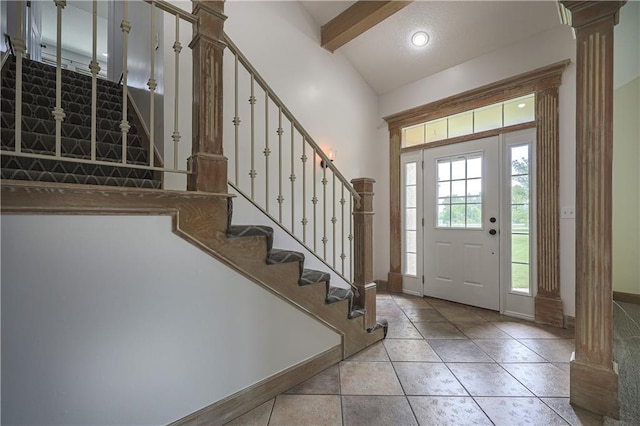 26528-23.09 S Metcalf Rd, Louisburg, KS 66053 - entrance foyer with stairway, decorative columns, beam ceiling, light tile patterned floors, and high vaulted ceiling