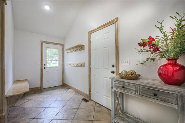 26528-23.09 S Metcalf Rd, Louisburg, KS 66053 - doorway to outside with lofted ceiling and light tile patterned floors
