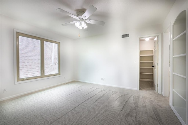 26528-23.09 S Metcalf Rd, Louisburg, KS 66053 - unfurnished bedroom with carpet, a spacious closet, a closet, and a ceiling fan