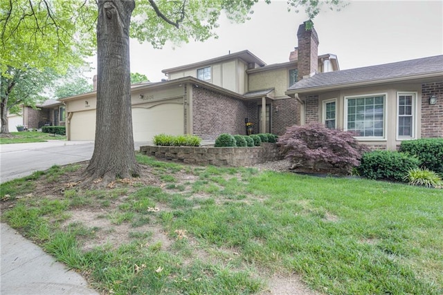 10902 W 96th Ter, Overland Park, KS 66214 - view of front of home with a garage, brick siding, a chimney, driveway, and a front lawn