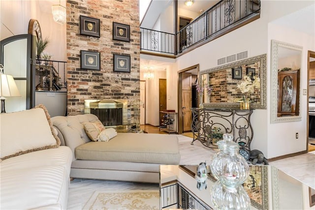 10902 W 96th Ter, Overland Park, KS 66214 - living room featuring a high ceiling and a brick fireplace