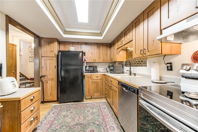 10902 W 96th Ter, Overland Park, KS 66214 - kitchen featuring stainless steel appliances, a raised ceiling, under cabinet range hood, light countertops, and light wood-style floors