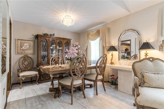 10902 W 96th Ter, Overland Park, KS 66214 - dining space with a chandelier and a textured ceiling