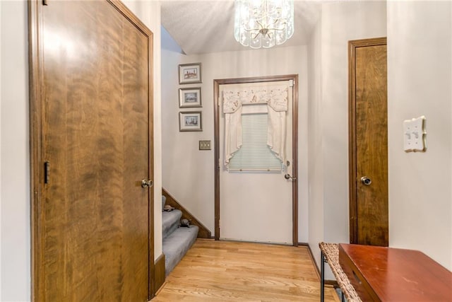 10902 W 96th Ter, Overland Park, KS 66214 - doorway to outside featuring a chandelier and light wood-type flooring