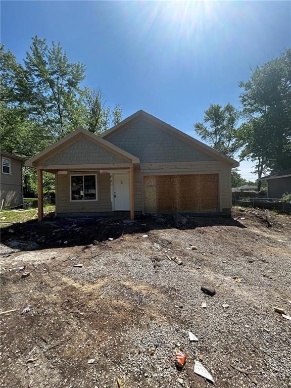 12003 Belmont Ave, Grandview, MO 64030 - view of front of home with an attached garage and driveway
