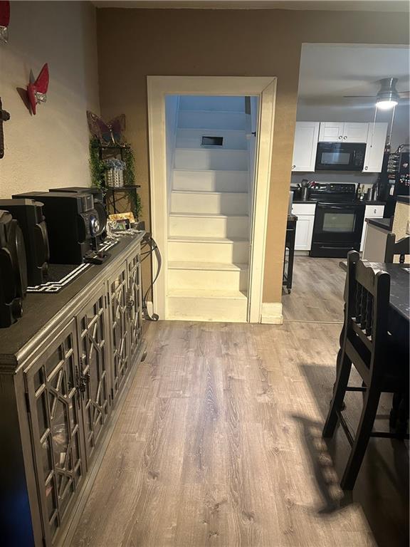 3823 Ruby Ave, Kansas City, KS 66106 - staircase featuring wood finished floors