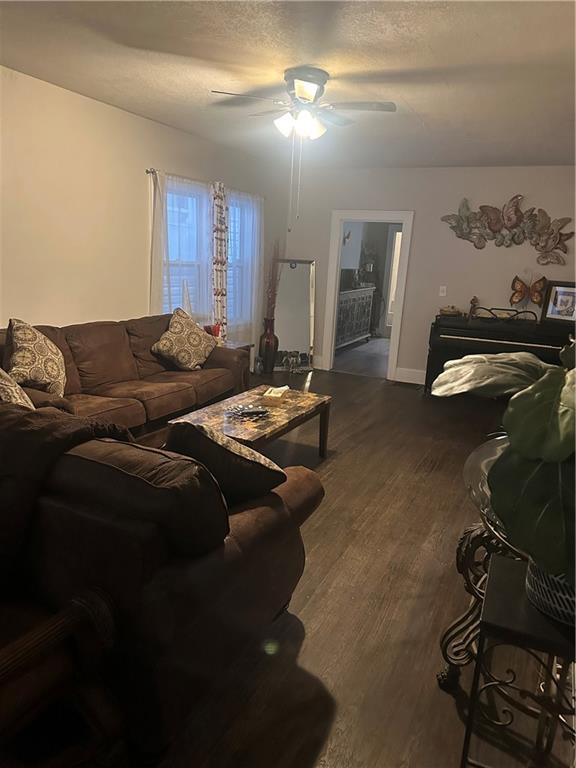 3823 Ruby Ave, Kansas City, KS 66106 - living area with a ceiling fan and dark wood-type flooring
