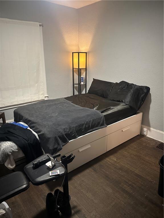 3823 Ruby Ave, Kansas City, KS 66106 - bedroom with dark wood-style floors and baseboards