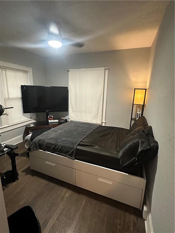 3823 Ruby Ave, Kansas City, KS 66106 - bedroom featuring dark wood-style floors and a ceiling fan