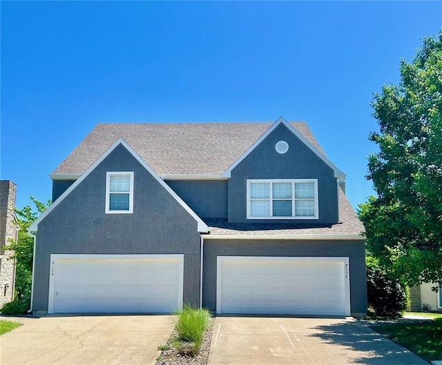 9219 Boehm Dr, Lenexa, KS 66219 - traditional-style home featuring concrete driveway, a garage, stucco siding, and a shingled roof