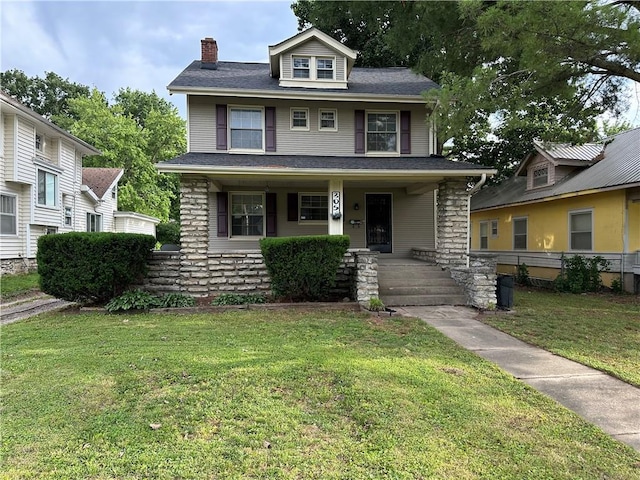 305 E Main St, Richmond, MO 64085 - traditional style home featuring a chimney, a porch, and a front yard