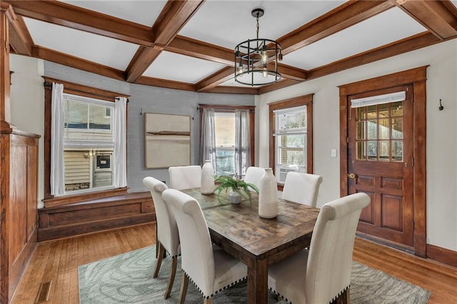 305 E Main St, Richmond, MO 64085 - dining space featuring wood finished floors, a chandelier, coffered ceiling, and beamed ceiling