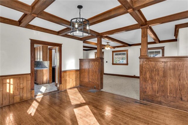 305 E Main St, Richmond, MO 64085 - empty room with coffered ceiling, hardwood / wood-style flooring, a wainscoted wall, beam ceiling, and a ceiling fan