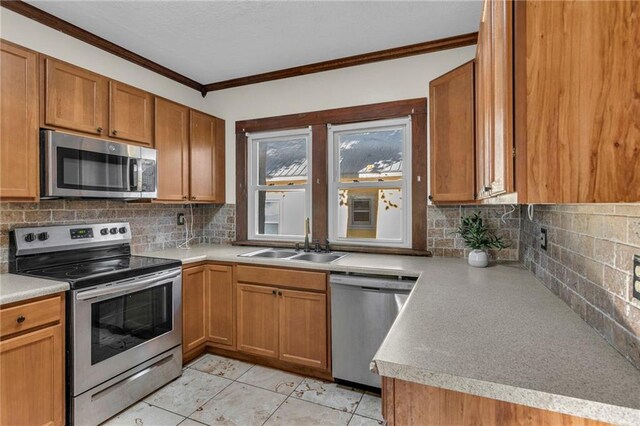 305 E Main St, Richmond, MO 64085 - kitchen with stainless steel appliances, crown molding, tasteful backsplash, light countertops, and brown cabinets