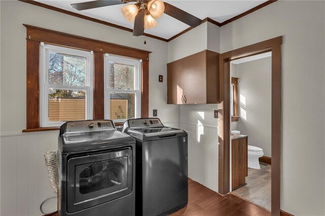 305 E Main St, Richmond, MO 64085 - laundry room featuring washing machine and dryer, ornamental molding, wood finished floors, and a ceiling fan