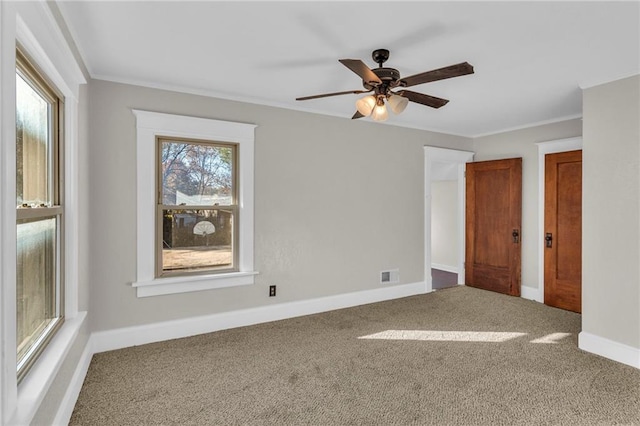 305 E Main St, Richmond, MO 64085 - carpeted spare room featuring crown molding and a ceiling fan