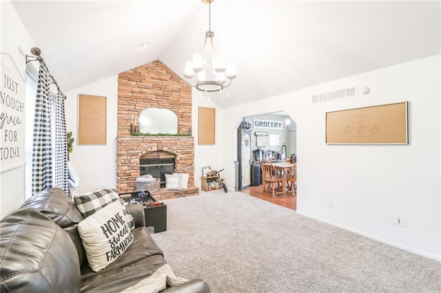 580 SE 110th St, Warrensburg, MO 64093 - carpeted living room featuring a chandelier, a fireplace, and lofted ceiling