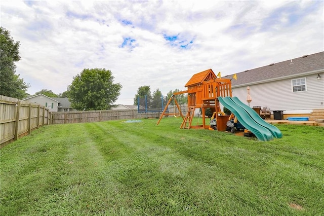 580 SE 110th St, Warrensburg, MO 64093 - fenced backyard featuring a trampoline and a playground