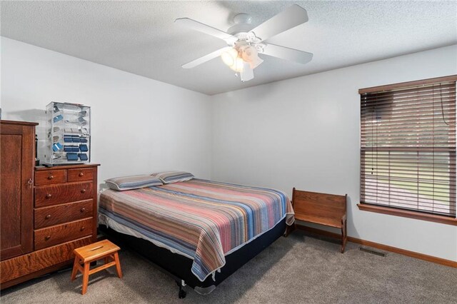 606 S Thornton St, Richmond, MO 64085 - bedroom featuring carpet, a textured ceiling, and a ceiling fan