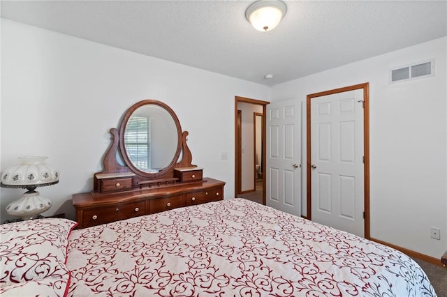 606 S Thornton St, Richmond, MO 64085 - carpeted bedroom with baseboards and a textured ceiling