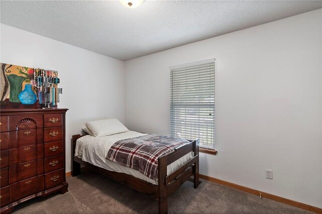 606 S Thornton St, Richmond, MO 64085 - bedroom featuring dark carpet and baseboards