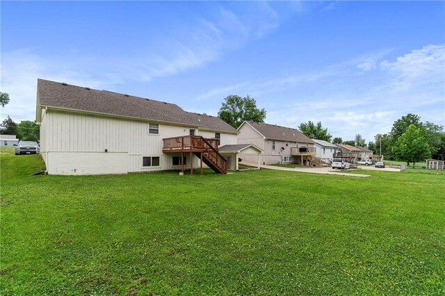 606 S Thornton St, Richmond, MO 64085 - back of house featuring stairs, a deck, and a yard