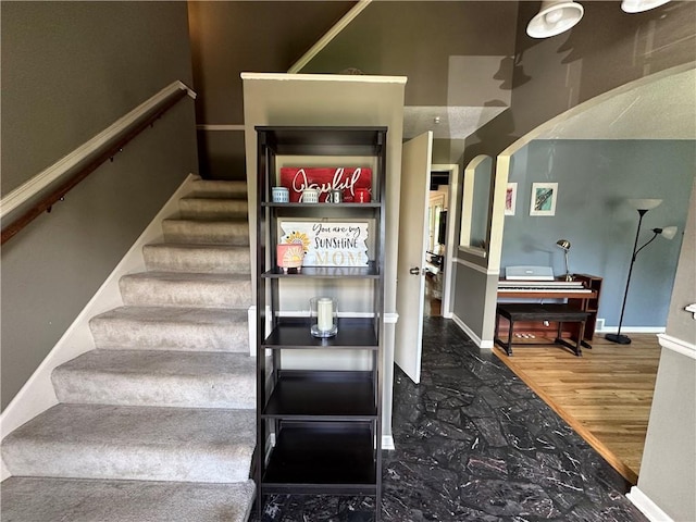 8708 W 92nd St, Overland Park, KS 66212 - staircase featuring arched walkways and wood finished floors