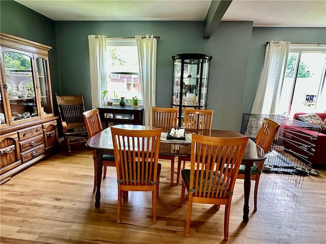 8708 W 92nd St, Overland Park, KS 66212 - dining room featuring light wood finished floors, a textured ceiling, and beamed ceiling