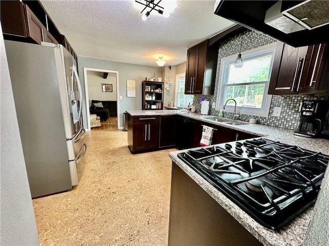 8708 W 92nd St, Overland Park, KS 66212 - kitchen featuring freestanding refrigerator, a peninsula, backsplash, stove, and a textured ceiling