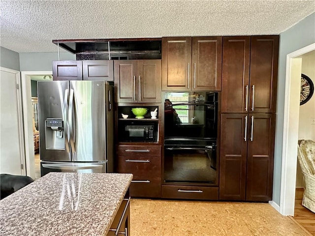 8708 W 92nd St, Overland Park, KS 66212 - kitchen featuring black appliances, a textured ceiling, light stone counters, and dark brown cabinetry