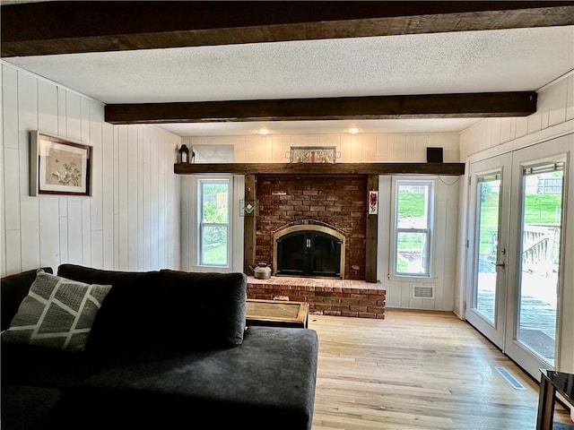 8708 W 92nd St, Overland Park, KS 66212 - living area featuring light wood-style flooring, healthy amount of natural light, beam ceiling, wood walls, and a fireplace