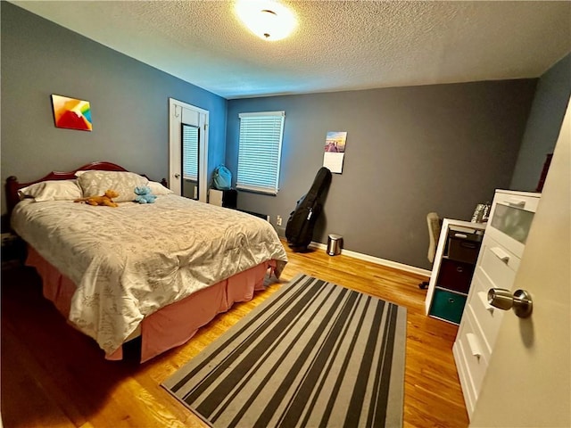 8708 W 92nd St, Overland Park, KS 66212 - bedroom featuring a textured ceiling and light wood-style floors