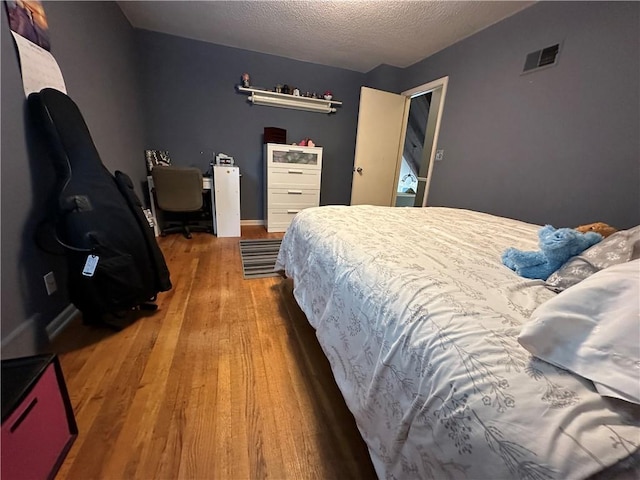 8708 W 92nd St, Overland Park, KS 66212 - bedroom with wood finished floors and a textured ceiling