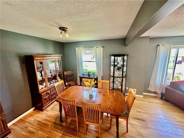 8708 W 92nd St, Overland Park, KS 66212 - dining space with a textured ceiling, light wood-style floors, and healthy amount of natural light