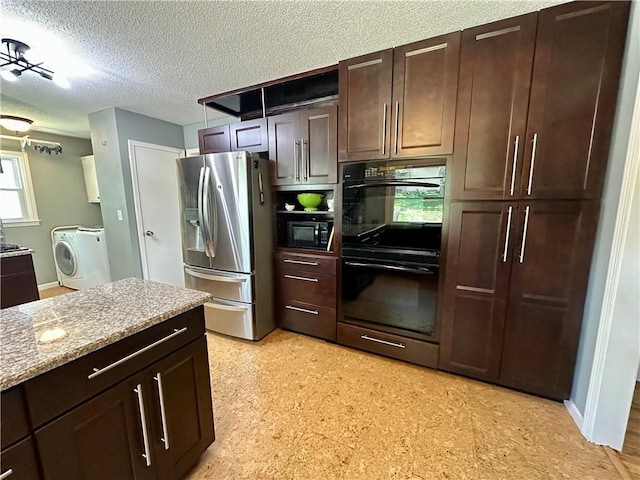 8708 W 92nd St, Overland Park, KS 66212 - kitchen with black appliances, washer / dryer, a textured ceiling, dark brown cabinets, and light stone counters