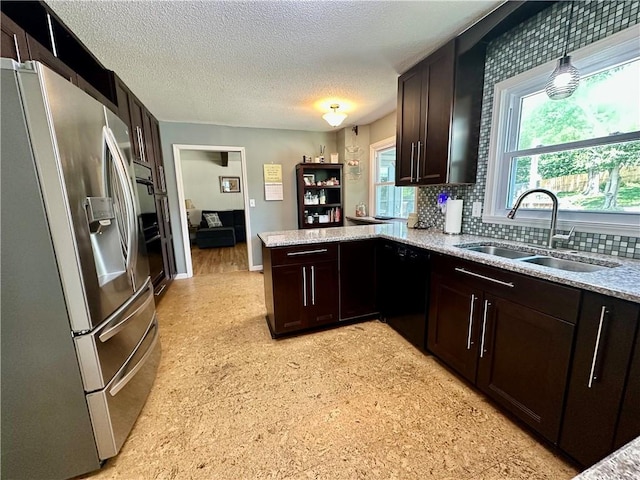 8708 W 92nd St, Overland Park, KS 66212 - kitchen with black appliances, a peninsula, a textured ceiling, dark brown cabinetry, and backsplash