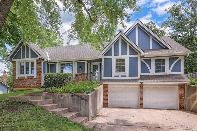 6919 Albervan St, Shawnee, KS 66216 - tudor house featuring brick siding, an attached garage, driveway, a shingled roof, and stucco siding