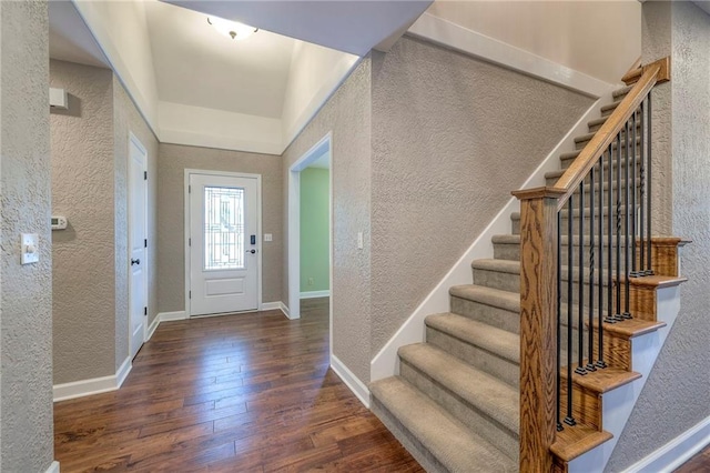 6919 Albervan St, Shawnee, KS 66216 - foyer entrance featuring a textured wall, hardwood / wood-style floors, and stairs