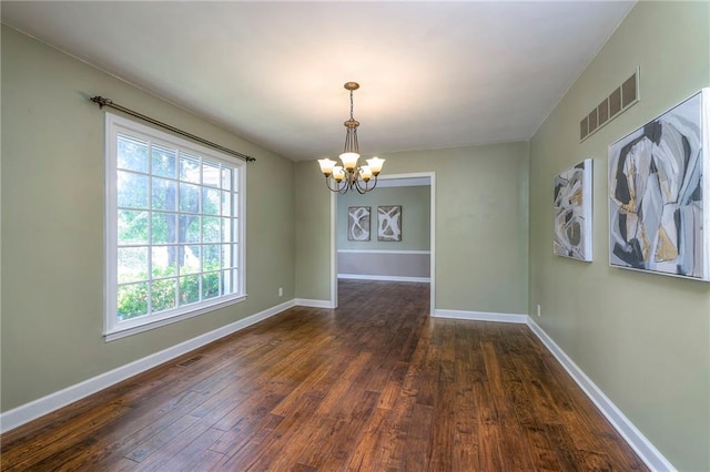 6919 Albervan St, Shawnee, KS 66216 - empty room with a chandelier and dark wood-type flooring