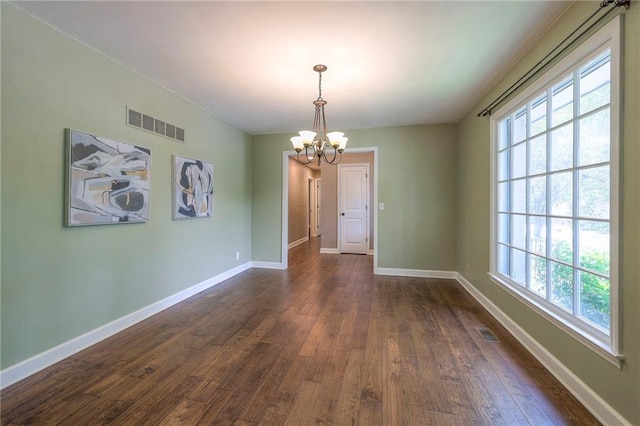 6919 Albervan St, Shawnee, KS 66216 - unfurnished dining area with a chandelier, dark wood-style floors, and healthy amount of natural light