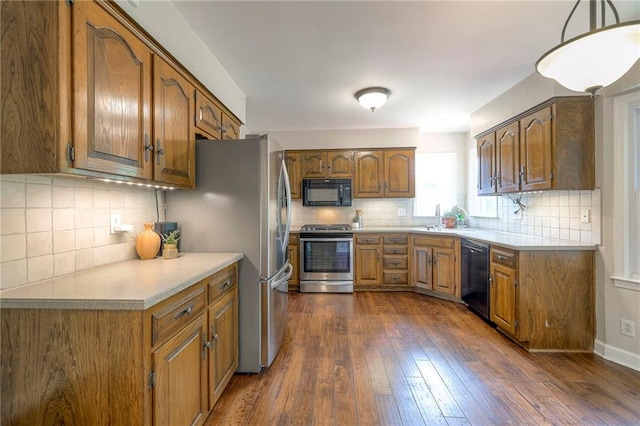 6919 Albervan St, Shawnee, KS 66216 - kitchen with black appliances, brown cabinets, and tasteful backsplash