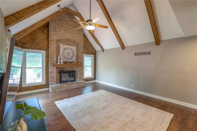 6919 Albervan St, Shawnee, KS 66216 - living area with ceiling fan, beam ceiling, a brick fireplace, dark wood-style floors, and high vaulted ceiling