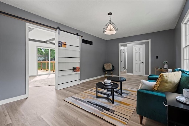 1208 SW Speas Dr, Blue Springs, MO 64014 - living area with a barn door and light wood-style flooring