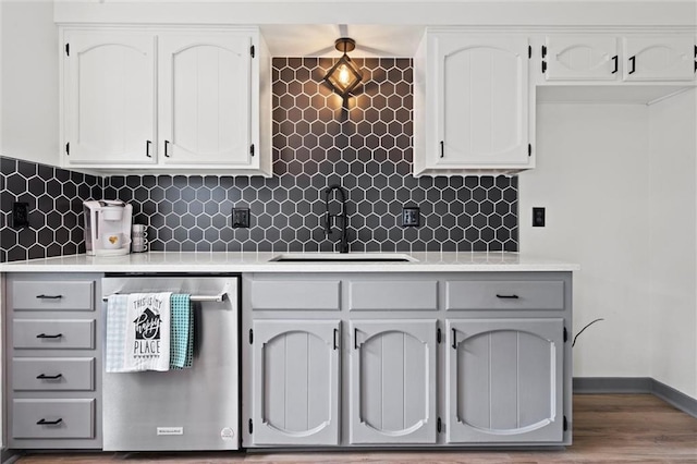 1208 SW Speas Dr, Blue Springs, MO 64014 - kitchen featuring dishwasher, white cabinetry, light countertops, and decorative backsplash