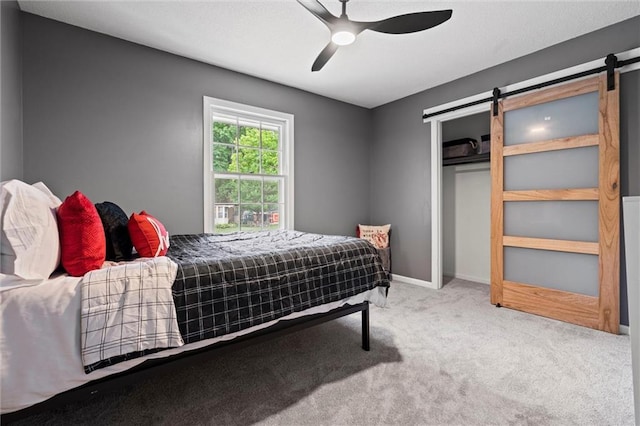 1208 SW Speas Dr, Blue Springs, MO 64014 - carpeted bedroom featuring a barn door, a closet, and ceiling fan