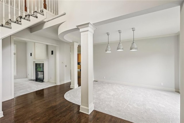 12909 Maple St, Overland Park, KS 66209 - unfurnished living room featuring ornate columns, carpet flooring, wood finished floors, a fireplace, and crown molding