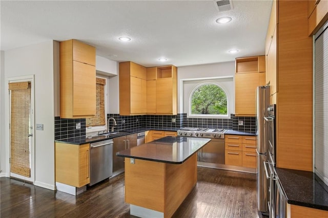 12909 Maple St, Overland Park, KS 66209 - kitchen with appliances with stainless steel finishes, dark wood-style floors, tasteful backsplash, a textured ceiling, and recessed lighting