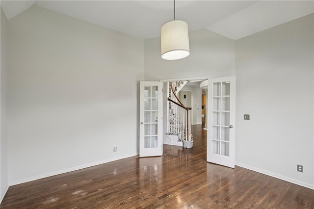 12909 Maple St, Overland Park, KS 66209 - unfurnished dining area featuring french doors, wood finished floors, arched walkways, stairway, and high vaulted ceiling