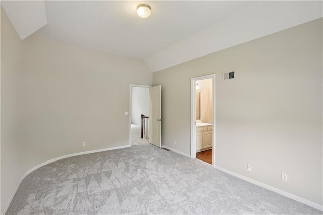 12909 Maple St, Overland Park, KS 66209 - unfurnished bedroom with carpet, lofted ceiling, and connected bathroom